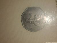 Front side of the 50 pence coin showing Britannia holding a trident and shield, with '50 PENCE' text.
