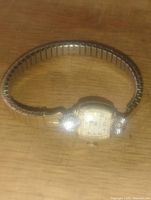 Full view of the Bulova gold filled ladies wristwatch with mechanical dial and diamond markers.