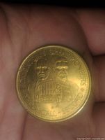 Obverse side of the commemorative token showing two men's portraits and text referencing Edmonton's Green Pioneers Society and McDougall School.