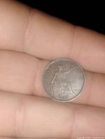 Reverse side showing seated Britannia with trident and shield and denomination FARTHING.