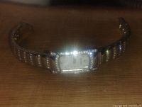 Front view of Bulova women's wristwatch on surface showing rectangular dial and crystal border.