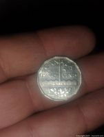 Reverse side of the 1951 Canada 5 cent coin featuring the denomination, landscape, beaver, and maple leaves design.