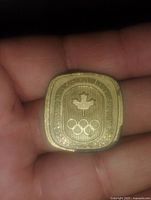 Photo showing the Canadian Olympic Association insignia side with maple leaf and Olympic rings.