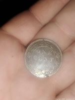 Reverse side of the coin showing 'ONE CENT 1906' with floral wreath design