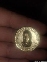 Front side of the medallion showing raised portrait of W.L. Mackenzie King and inscription of years 1921, 1926, 1935.