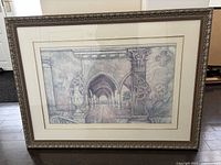 Framed architectural print artwork in dark decorative frame with light beige mats.