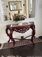 Front view of console table against wall with decorative mirror and accessories (not included).