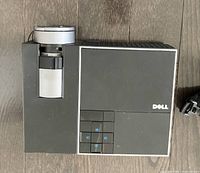 Top view of the Dell projector showing lens and control buttons