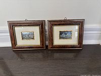 Front view of both mini picture frames showing dark wood finish, gold trim, and metallic inset artworks.
