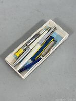 Box containing two Waterman's pens and an instruction sheet inside.