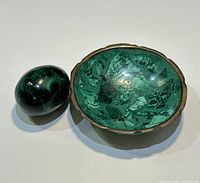 Bowl and egg displayed side by side on white background