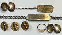 Photo showing gold filled rectangular cufflinks, gold filled chain tie bar engraved 'Robert S. Grant', gold filled dog tag with engraved script and chain, and three round gold filled buttons marked 'Military Sons'.