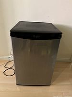 Front view of the Danby mini fridge showing stainless steel door and black top.