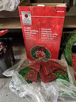 Photo of the boxed wreath showing the product branding and details on packaging.