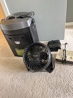 Overview photo showing all three items: Royal shredder, Honeywell fan, Sony radio with power strip.