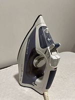 Rowenta steam iron standing upright showing side control dial and steam functions.