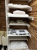 Overall shelf view showing all bedding items and textiles