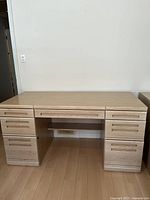 Front view of Palliser wood office desk with six drawers.