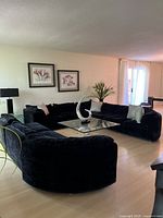 Full view of L-shaped modular sofa arranged around a glass coffee table