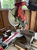 Milwaukee 12-inch sliding compound miter saw mounted on stand