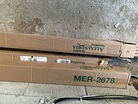 Two cardboard boxes labeled 'MER-2678 Alexandria Moulding' containing crown moulding pieces