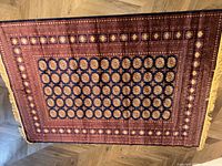 Full top-down view of the carpet showing the rectangular shape, detailed border, and central medallion pattern.