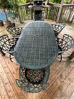 Full view of oval table with six chairs on deck
