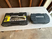 Two closed socket sets in their cases: Stanley 183-piece set and Mastercraft set.