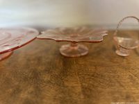 Close-up of flower-shaped candy dish edge showing detail and thickness of pink glass