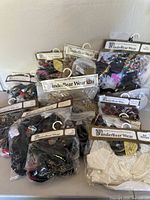 Photo showing 10 vintage Vander Bear Wear clothing items for bears, all sealed in original packaging, assorted styles and colors.