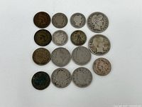 Overview of all 15 miscellaneous coins arranged in a grid on white surface.