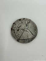 Obverse side of the 1865 Seated Liberty half dollar coin showing the seated Liberty figure with the date 1865 and 13 stars around.