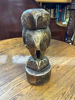 Front view of the ceramic owl statue showing detailed texture and sculpting on the head and body.