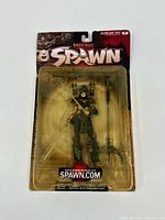Front view of Dark Ages Spawn action figure in original sealed blister packaging showing figure and weapon accessory