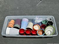 Overhead view of all 20 assorted plant pots showing mix of ceramic, plastic, and terracotta varieties in different colors and sizes.