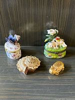 All four small decorative trinket boxes arranged in one photo, showing variety in style and materials