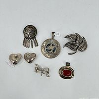 Top-down photo of all six sterling silver jewelry items arranged on white background.