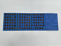 Photo of open booklet pages showing multiple Lincoln Head pennies in slots arranged by year beginning at 1941.