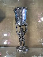 Full view of the hammered metal goblet held by the wizard figure base.
