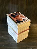 Stack of mixed baseball cards with a 1985 Topps card featuring a San Francisco Giants player on top