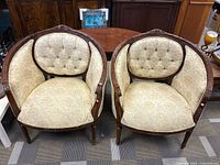 Pair of Victorian style wishbone chairs showing front and side profiles, cream floral upholstery, carved wood frames
