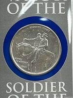 Close-up photo of the 1995 silver half dollar coin showing two mounted soldiers, one pointing forward, with detailed inscriptions including 'SOLDIER OF THE SOUTH'