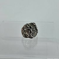 Front view showing the detailed woman face design and decorative accents on the sterling silver ring.