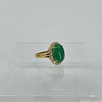 Side profile of the ring highlighting the gold vermeil band and oval jade stone setting.