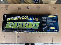 Top view of the sealed Complete Soccer Skill Kit box showing training exercise images and promotional text.
