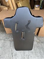 Front view of the football blocking dummy showing two reinforced handles for gripping and a padded black surface.