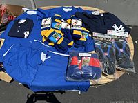 Wide shot of all items on display including shirts, shorts, socks, shin guards in packaging.