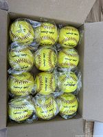 Box containing 12 yellow Little League baseballs individually wrapped in plastic.
