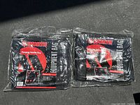 Two Worth Hanging Helmet Equipment Bags in original sealed plastic packaging, black color with red and white branding visible.