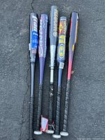 Top view of all five aluminum baseball bats, showing grips and barrel ends